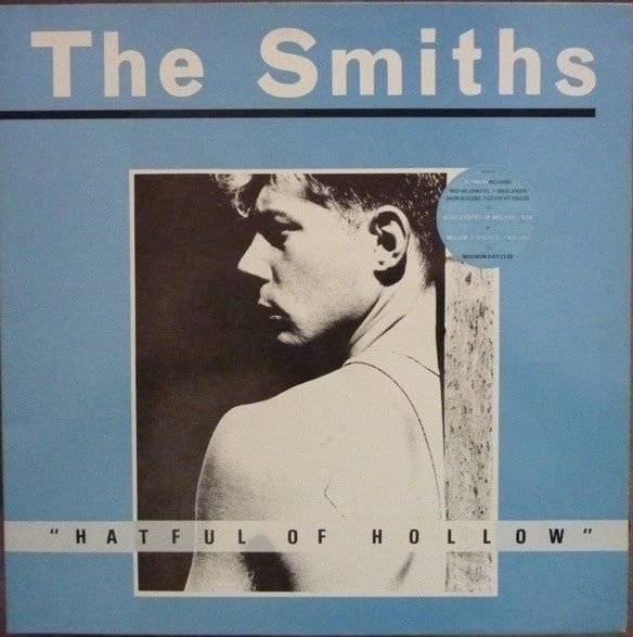 The Smiths Hatful of Hollow 1984 album cover featuring monochrome photo of a man in a vest on a blue background