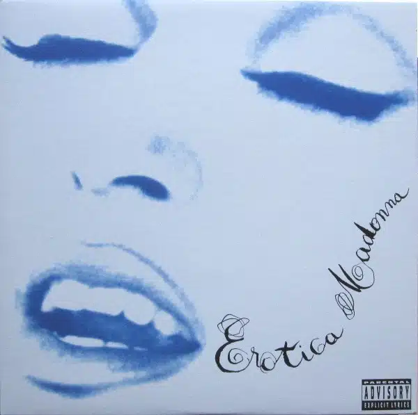 Madonna Erotica Album Turns 33 – Why This Important Album Still Matters Close-up of Madonna's face in blue tones on the Erotica album cover, with stylized handwritten title and Parental Advisory logo.