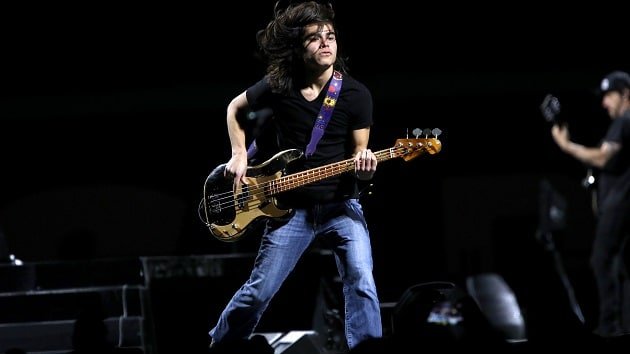 Tye Trujillo Signature Wah Pedal Launches July 1 via Morley Tye Trujillo performing live on stage with a bass guitar, mid-motion during a concert set.