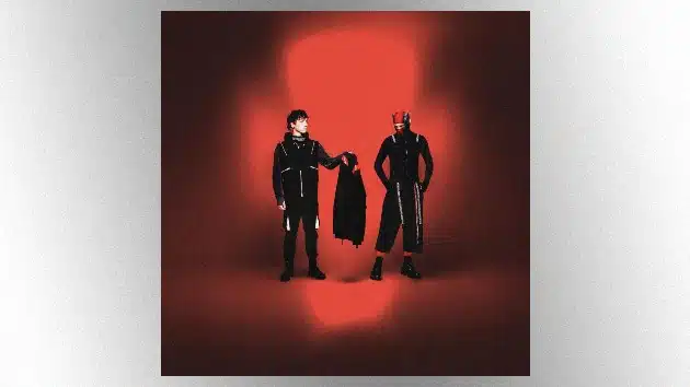 “The Crutch” Marks a New Era for Twenty One Pilots Ahead of 2025 U.S. Tour Twenty One Pilots pose against a red spotlight backdrop for “The Crutch” single cover