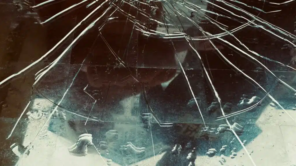 New Album Releases 2025: This Week’s Must-Hear Tracks and Announcements Cracked glass surface with spiderweb-like fractures and faint reflections beneath