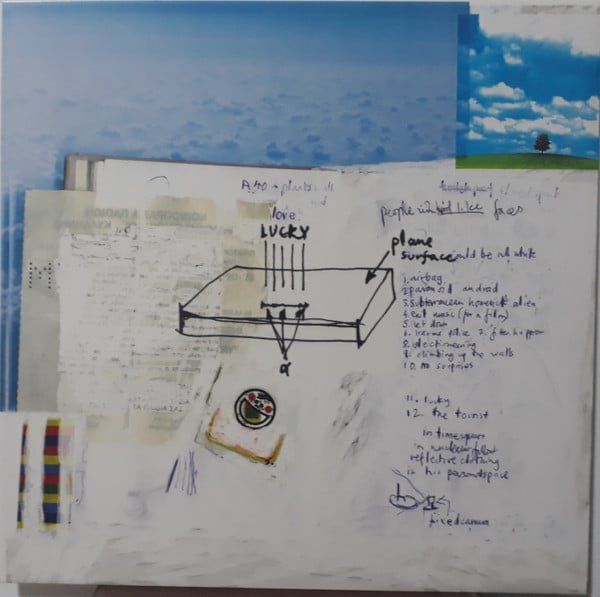 Radiohead – OK Computer Album: Why It’s Still the Best Album of the 1990s Radiohead OK Computer inner sleeve with handwritten tracklist, abstract sketches, and sky imagery