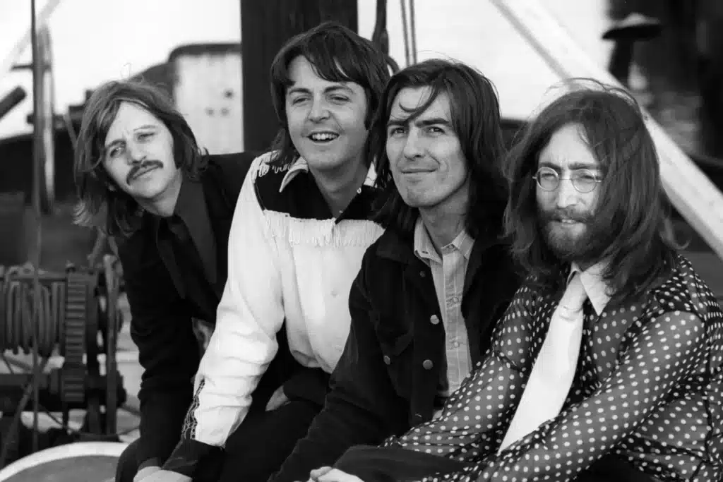 The Beatles in 1969: Ringo Starr, Paul McCartney, George Harrison, and John Lennon seated together during the Abbey Road recording era.