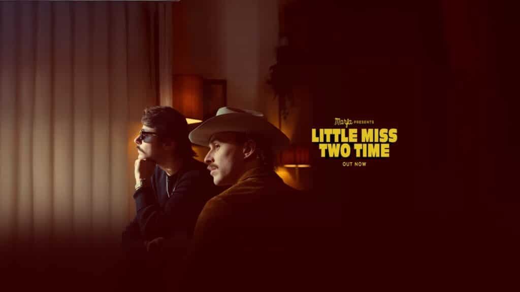 Marfa band members in a moody, dimly lit room with warm lighting, promoting their new single “Little Miss Two Time” — text overlay reads “Out Now.”