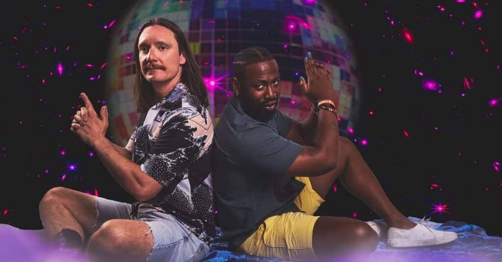 Glamour Shot band members pose in front of disco ball background, Denver 2025