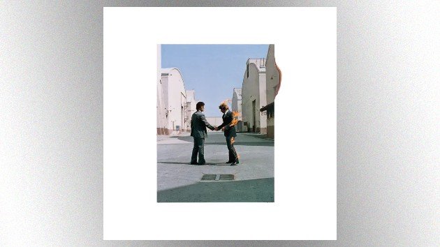 Pink Floyd Wish You Were Here album cover featuring two businessmen shaking hands, with one of them set on fire, photographed by Aubrey “Po” Powell.