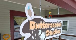 Butterscotch Studios sign hanging outside the Longmont, Colorado women-owned music and art collective