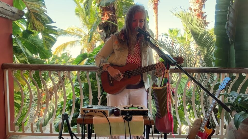 Jen Korte performing as Lady Gang with guitar and loop station during a live show in Colorado