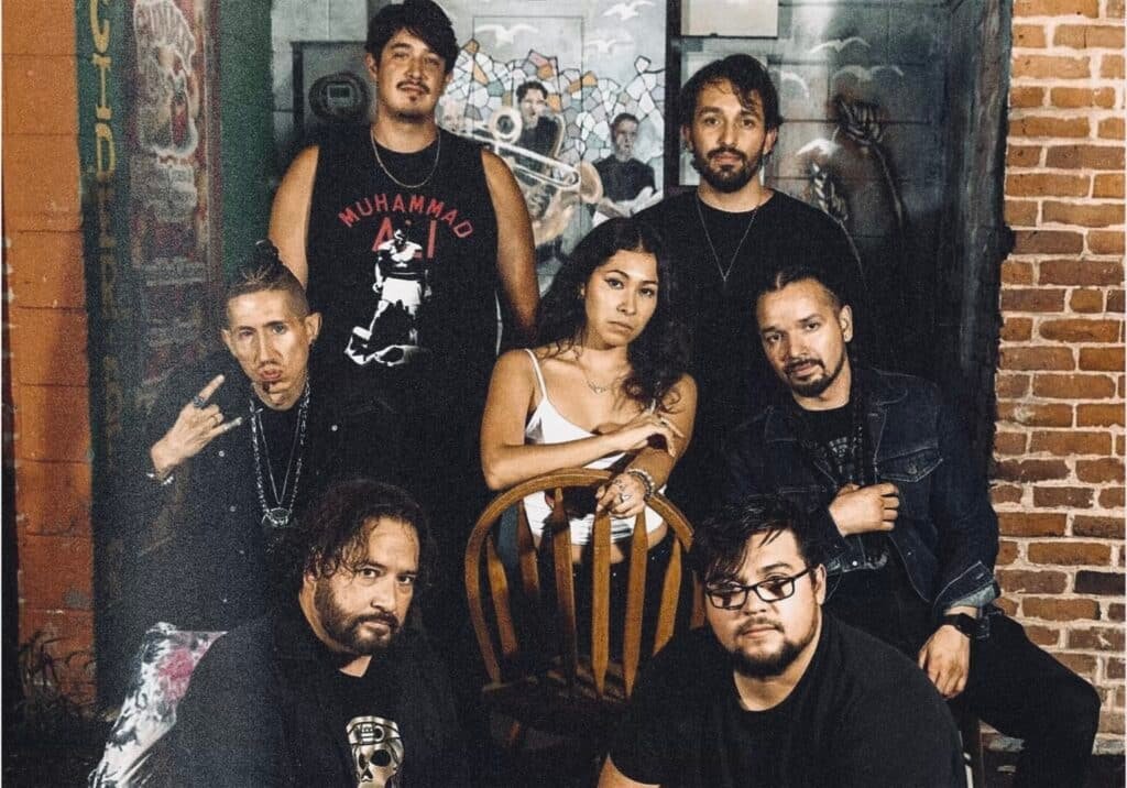 2MX2 Denver band group photo featuring Owen Trujillo, Juice E Hugo, Lolita, DMD, Kenny O, Adrian Garay, and Eastlin