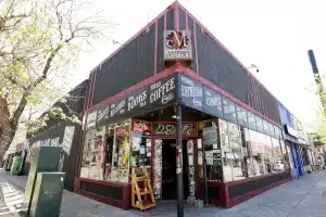 Exterior of Mutiny Information Cafe on South Broadway in Denver, featuring its storefront for books, records, comics, and coffee.