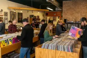 Customers browsing vinyl records at a Longmont record store during rising vinyl sales 2025 Longmont