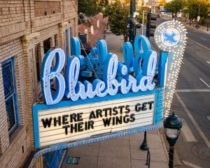 Historic Bluebird Theater in Denver neon marquee sign on East Colfax Avenue reading "Where Artists Get Their Wings.