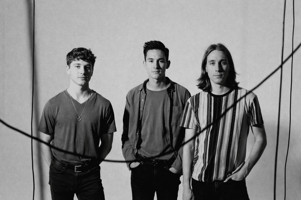 Black and white promotional portrait of the band Holdfast featuring Charlie, Tommy, and Mikey Maddocks for the Holdfast NYE 2025 show in Denver. (Why: It describes the visual content for accessibility while naturally working in the "Holdfast NYE 2025