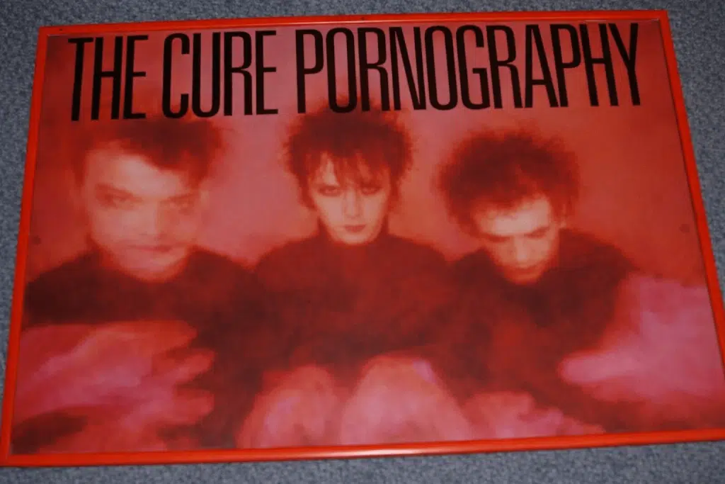 The Cure Pornography vinyl album cover featuring the band in a red-tinted, blurred portrait design.
