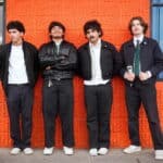 Denver indie rock band BRŪHA posing outside a Denver venue