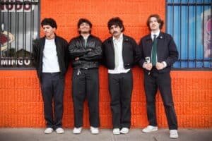 Denver indie rock band BRŪHA posing outside a Denver venue