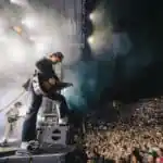 Djo performing live on stage during a high-energy concert