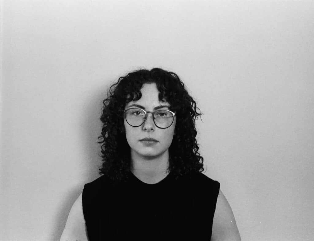 Portrait of Nicki Walters, a Denver-based queer folk musician known for maximalist folk and 2026 Treefort Music Fest performances.